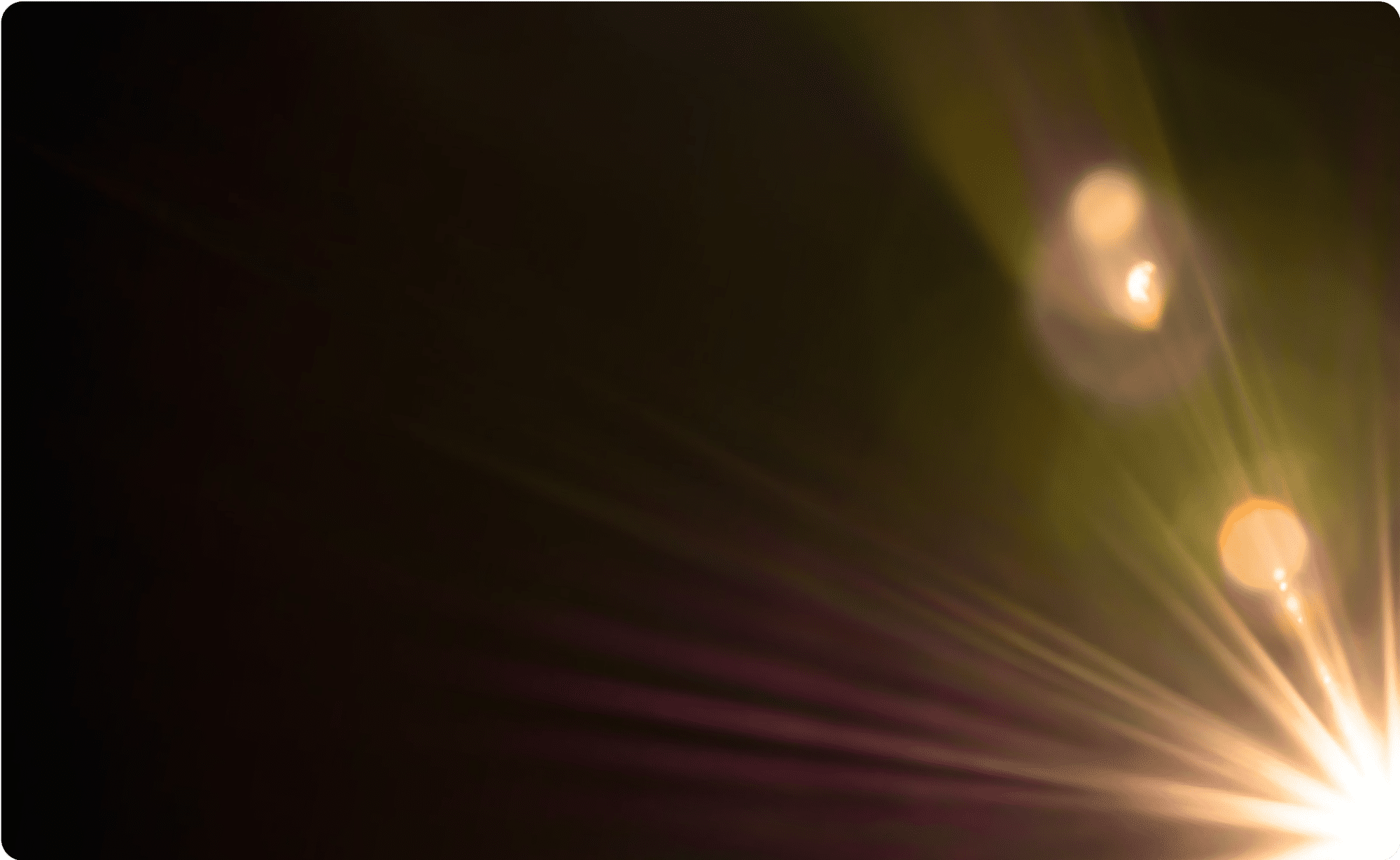 Bright light rays against a dark background with vibrant lens flares.