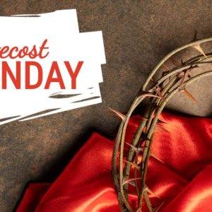 Crown of thorns on red cloth with a banner reading Pentecost Sunday.