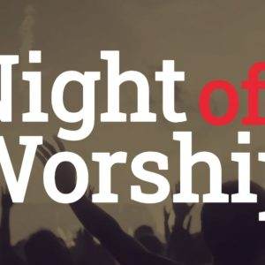 People with raised arms at a night of worship event