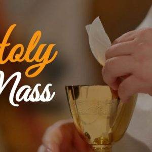 Priest holding a golden chalice and communion wafer during Holy Mass ceremony