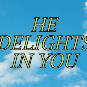 Sky with scattered clouds and the text "He Delights In You" in bold yellow letters.