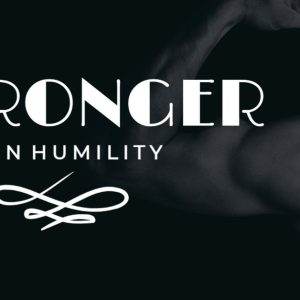 Stronger in Humility slogan with muscular arm in dark background