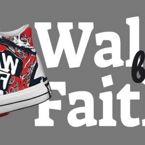 Red and black sneakers with motivational text 'Walk by Faith' on a grey background.