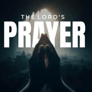 Hands folded in prayer with the text "The Lord's Prayer" in a dimly lit, sacred setting