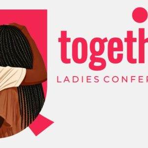 Two women embrace at the 'Together Ladies Conference' with a bold red background.