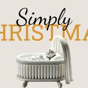 Elegant white crib with a draped white blanket, emphasizing the holiday theme of Simply Christmas.