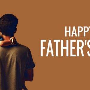 Father carrying his child with a Happy Father's Day greeting on a brown background.