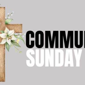 Wooden cross adorned with white lilies next to the text "Communion Sunday" on a gray background.