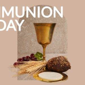 Golden chalice with wine, bread, wheat, and grapes on Communion Sunday.