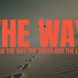 Footprints on a serene sand dune under a dramatic sky with the text 'The Way' superimposed.