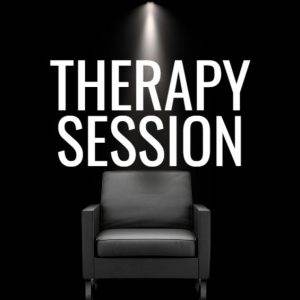 Therapy session chair under spotlight with black background