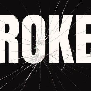 Cracked glass with the word 'BROKEN' in bold white letters on a black background.