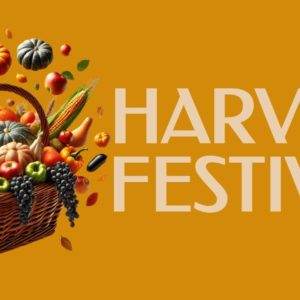 Autumn fruits and vegetables in a wicker basket with falling leaves on an orange background next to 'Harvest Festival' text