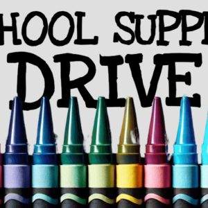 A variety of colorful crayons lined up under the text 'School Supply Drive'.