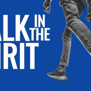 Person walking energetically in jeans and sneakers against a vibrant blue background with the words "Walk in the Spirit".