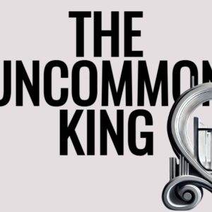 Modern sculpture with stylized text "The Uncommon King" against a light background.