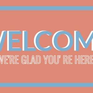 Welcome sign with text "We're glad you're here" on a peach background