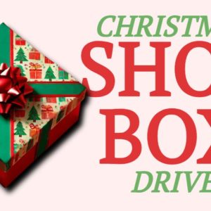 A festive gift box with a red bow, symbolizing a Christmas Shoebox Drive.