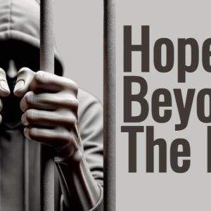 Person gripping prison bars with caption "Hope Beyond the Bars"