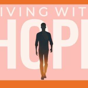 Silhouetted person walking towards light with the words "Living with Hope" in bold on a pink and orange background.