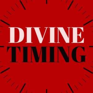 Red clock face with the words Divine Timing in bold letters