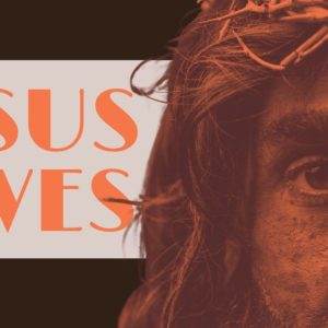 Close-up of a face wearing a crown of thorns with the phrase 'Jesus Saves' in bold orange text.