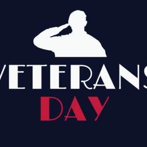 Veterans Day tribute with silhouette of soldier saluting and American flag elements.