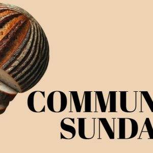 Artisan bread loaf with text "Communion Sunday" on a beige background.