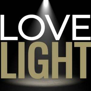 Dramatic spotlight on the words "Love & Light" in bold against a dark background.