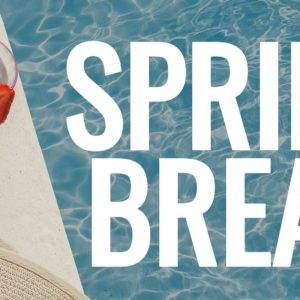 A refreshing drink by the pool with sunglasses, hat, and clear blue water, highlighting a spring break atmosphere.