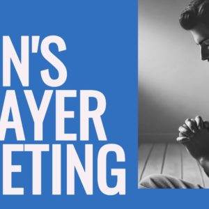 Man praying indoors at a men's prayer meeting