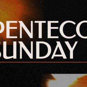 Pentecost Sunday text with vibrant orange and black abstract background.