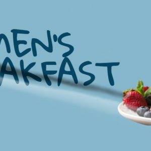 Stack of pancakes with syrup, strawberries, and blueberries against a blue background with the text "Men's Breakfast."