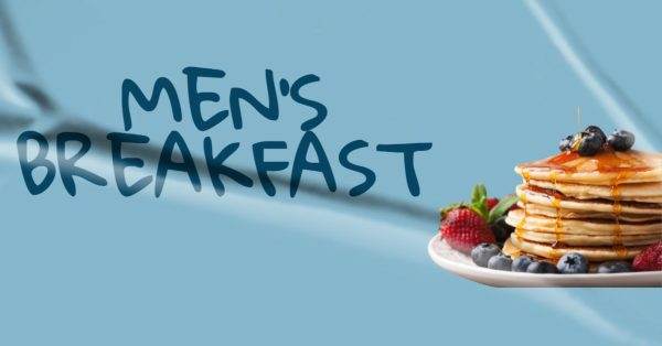 Stack of pancakes with syrup, strawberries, and blueberries against a blue background with the text "Men's Breakfast."